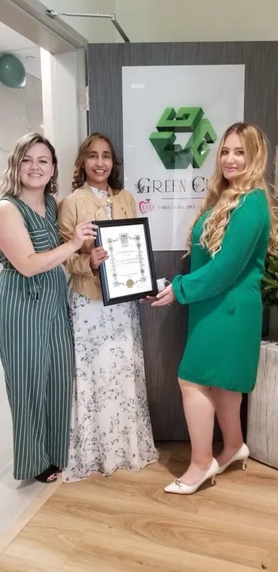 Naila receiving an award plaque