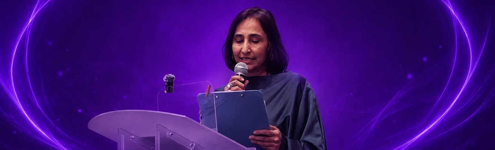 Naila Saeed speaking at a podium