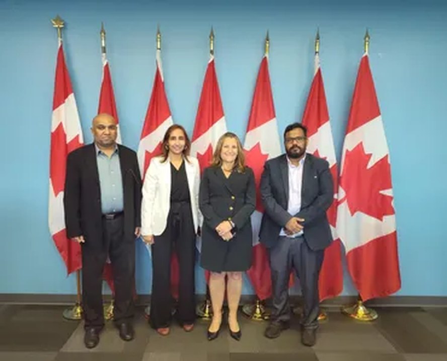 Naila with community leaders and Canadian flags